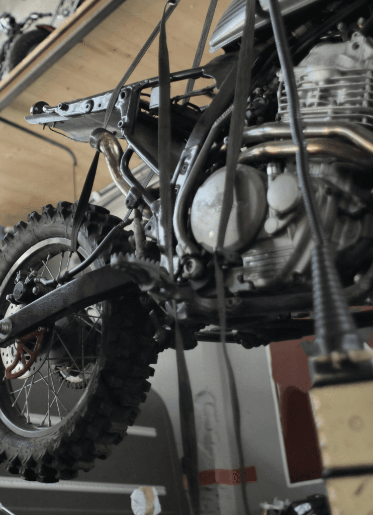 Close up of Go-karts Quads & Bikes, dirt bike being worked on in the workshop for service