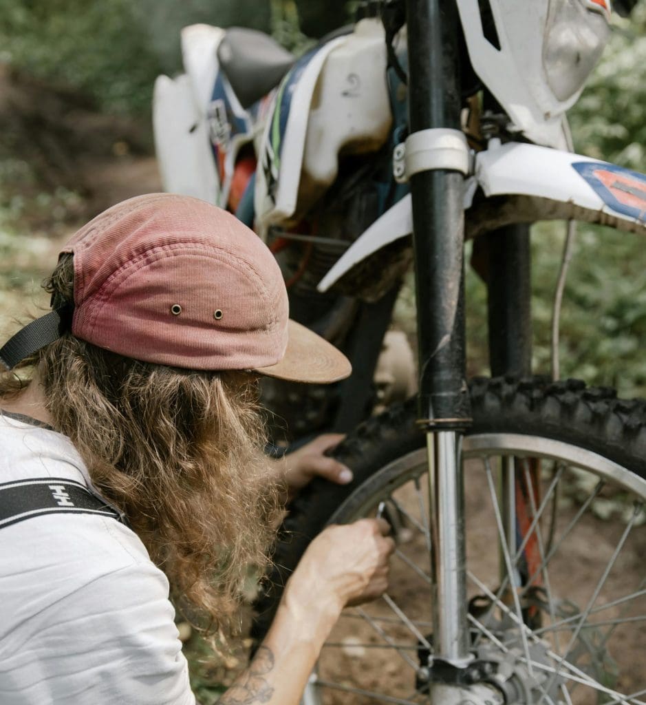 Man fixing Go-karts Quads & Bikes, dirt bike tire for service